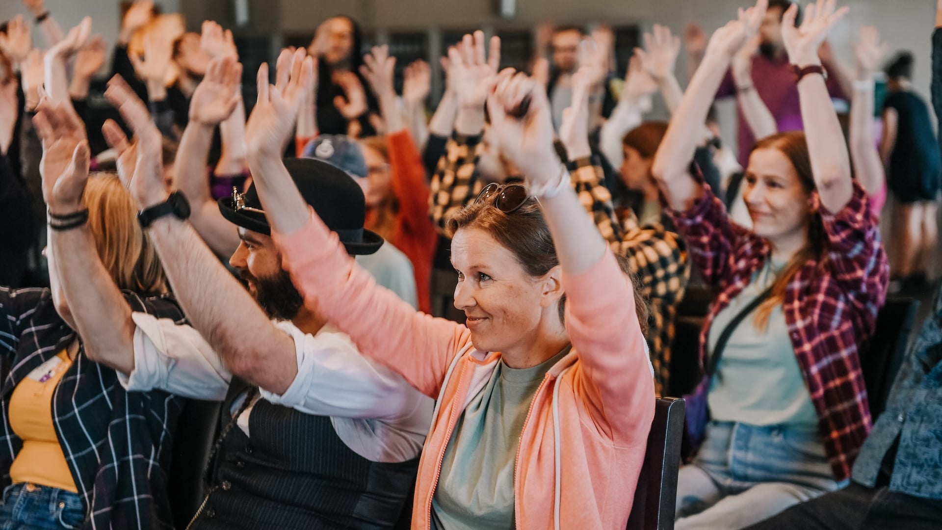 Mearra colleagues raising their hands during a shared team session